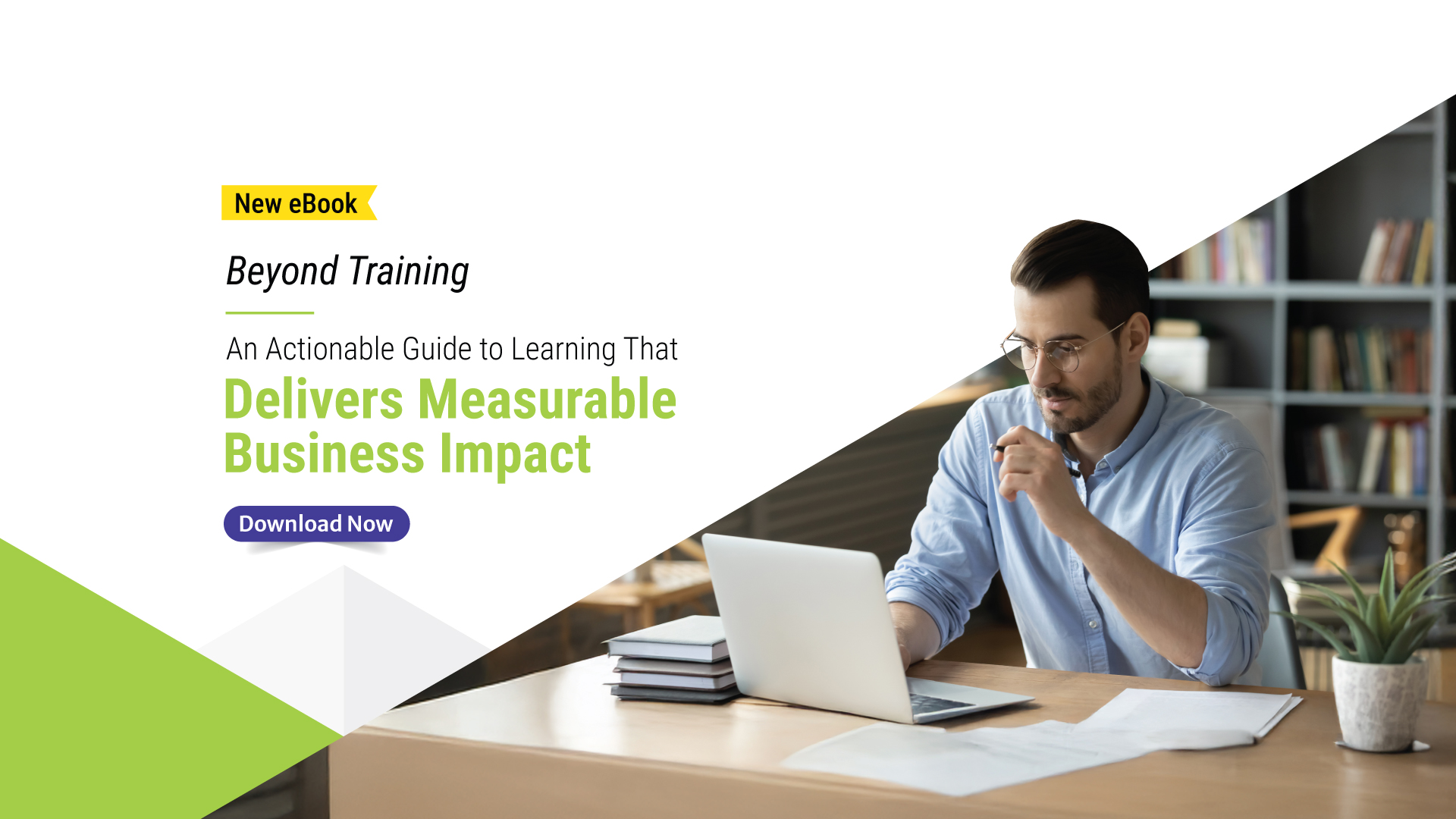 Man in glasses working on a laptop at a desk with documents and a plant, next to text promoting Upside Learning’s eBook “Beyond Training: An Actionable Guide to Learning That Delivers Measurable Business Impact,” with a Download Now button.